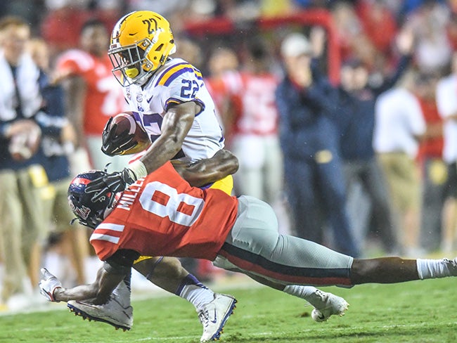 LSU coach Ed Orgeron celebrates with running back Clyde Edwards-Helaire  (22) after a touchdown …