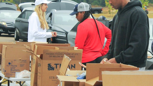 Ole Miss athletes partner with Wheels Up, Grove Collective, and Brandr Group to aid Oxford families through a service day at Mid-South Food Bank.